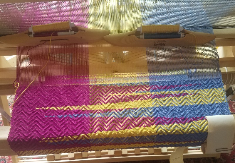 A Loom with a colorful project in progress
