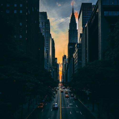 A glimpse of sunset between a canyon of skyscrapers.